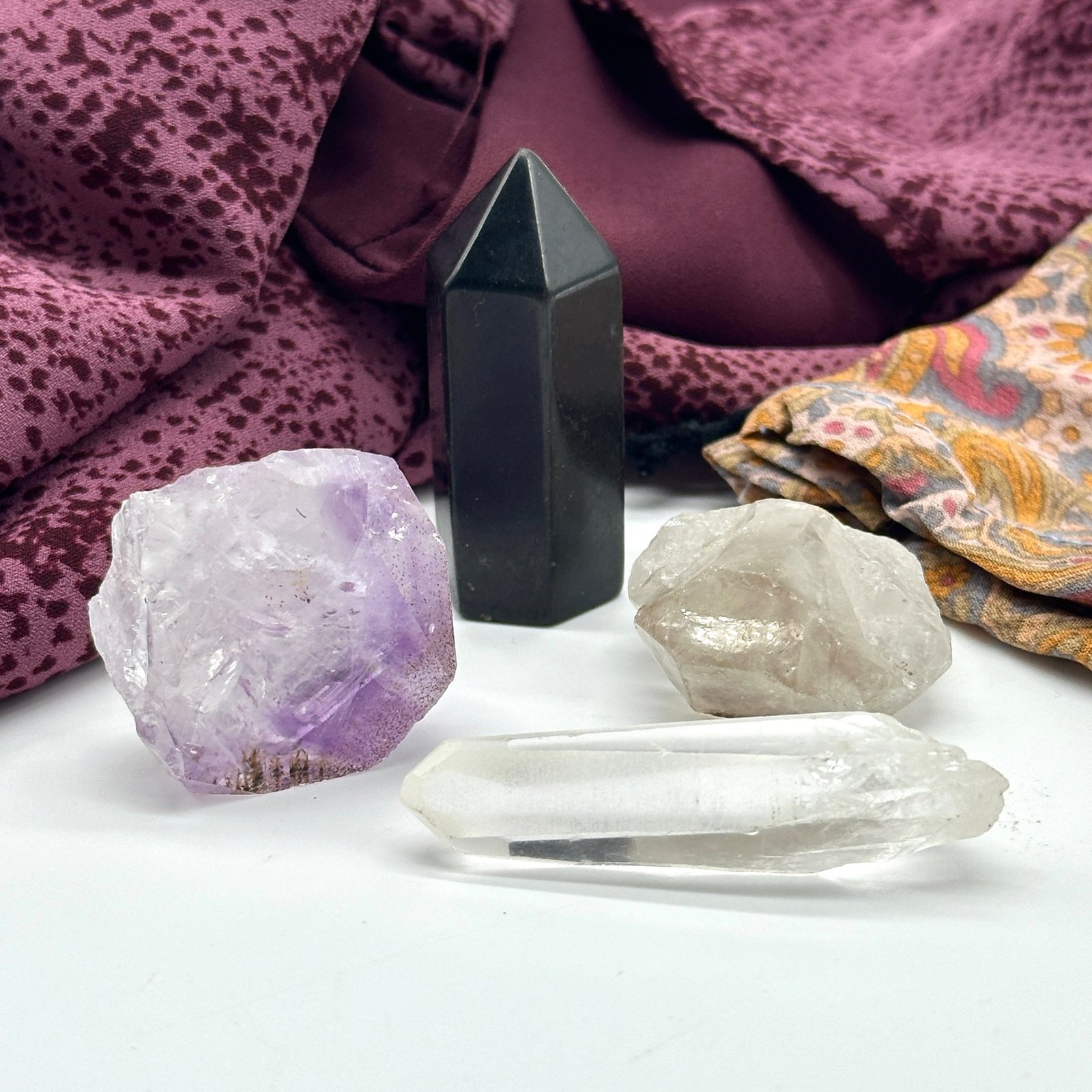 Crystal Set of Four Includes: Tibetan Smoky Quartz DT Point, Amethyst Rutile Natural Point, Mini Lemurian Seed Quartz Crysal, Mini Shungite Tower Crystal Set of Four Includes: Tibetan Smoky Quartz DT Point, Amethyst Rutile Natural Point, Mini Lemurian Seed Quartz Crysal, Mini Shungite Tower